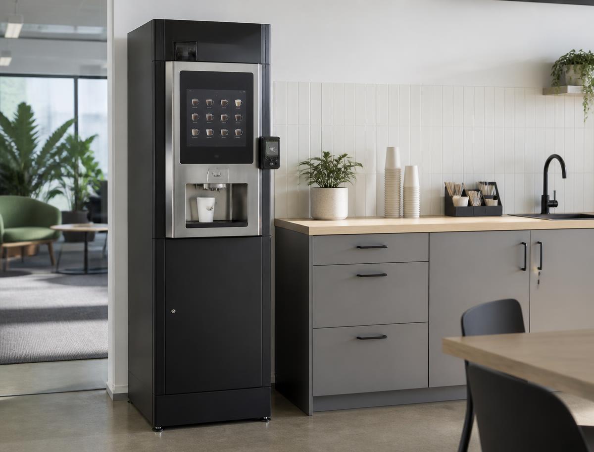 Free coffee vending machine installed in a Melbourne office kitchen beside cups and stirrers